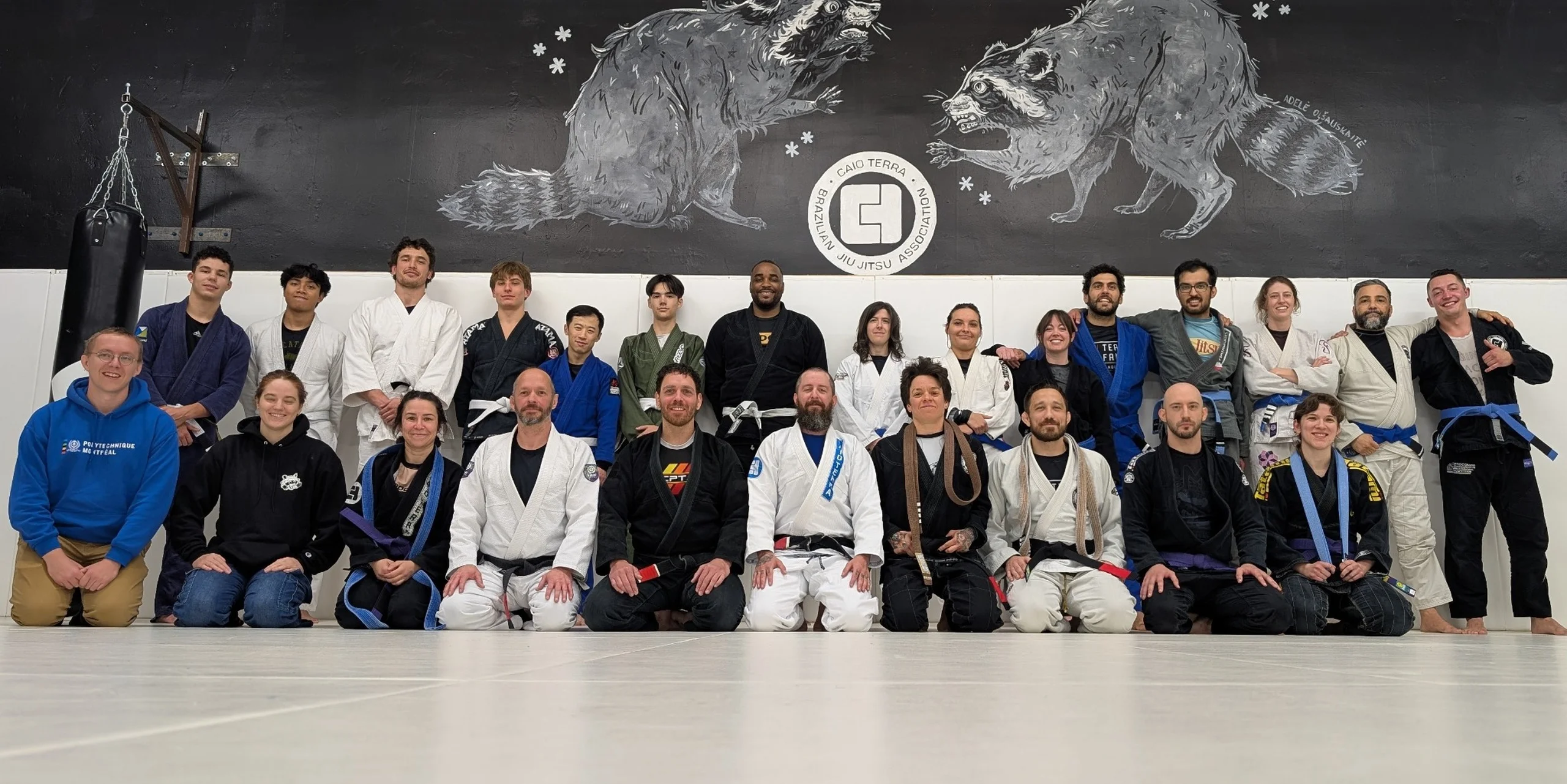 Plateau BJJ – Caio Terra Association academy group photo in front of mural.